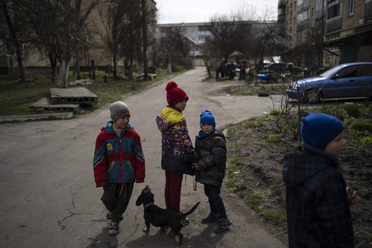 Children walk in Bucha on the outskirts of Kyiv, Ukraine, on April 8, 2022. Local authorities told The Associated Press that at least 16 children were among the hundreds of people killed in Bucha. Photo: AP