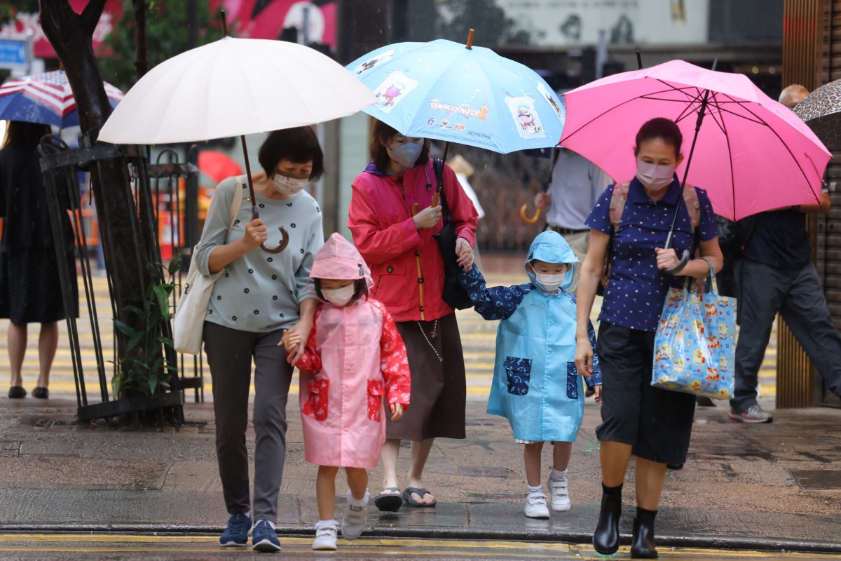 In spite of the heavy rain, many students say they would prefer to attend school in person, since they lost so much class time during the fifth wave of Covid-19. Photo: Nora Tam