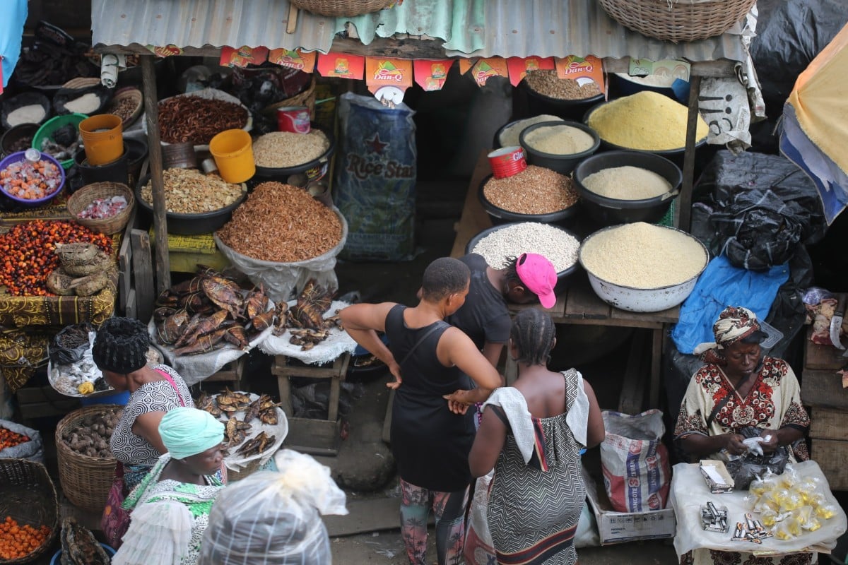 Women shop for foodstuff at the Mile 12 International food market in Lagos, Nigeria, on June 9, 2022. The cost of food and agricultural products are on the rise and people, as well as the farmers, are complaining about the cost of food production, citing insecurity; the cost of transportation, and unreliable road infrastructure to get the food products to the market. Photo: EPA-EFE