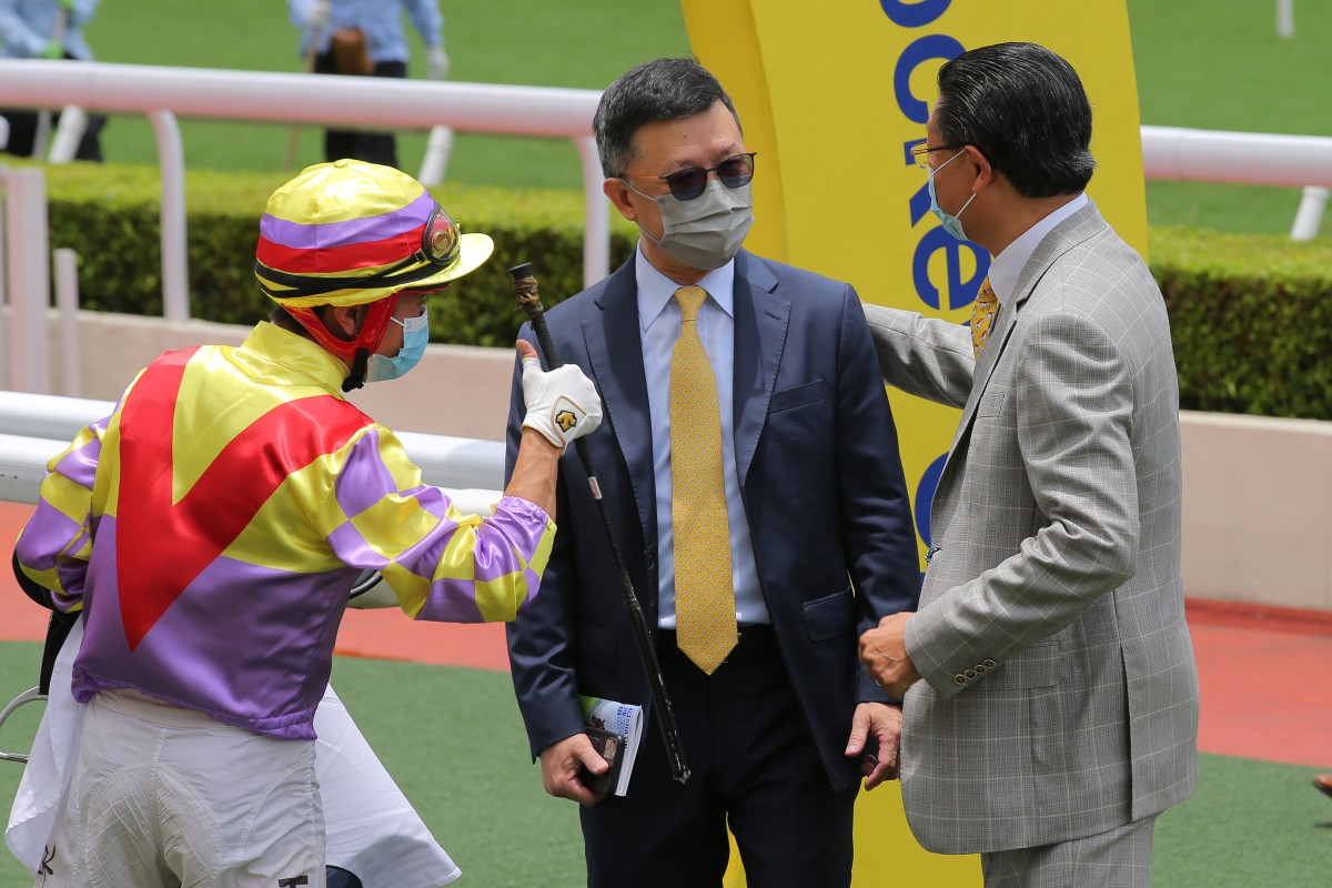 Peter Ho is congratulated by jockey Dylan Mo after Dashing Triumph’s debut success. Photo: Kenneth Chan