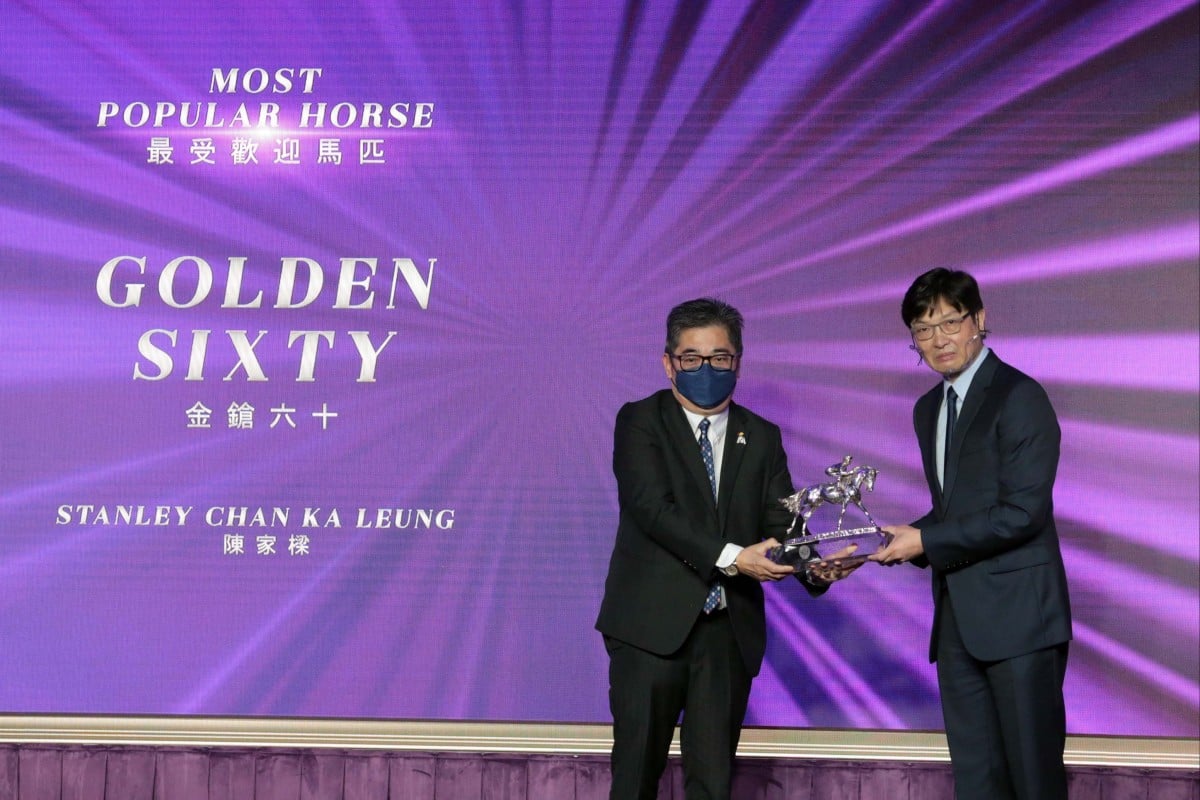 Golden Sixty’s owner Stanley Chan Ka-leung picks up the award for Most Popular Horse of the Year. Photo: HKJC