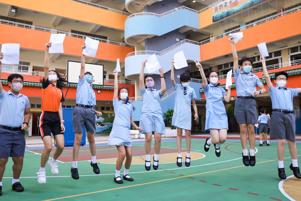 Students at Yaumati Catholic Primary School (Hoi Wang Road) jump for joy after collecting the allocation results. Photo: K. Y. Cheng