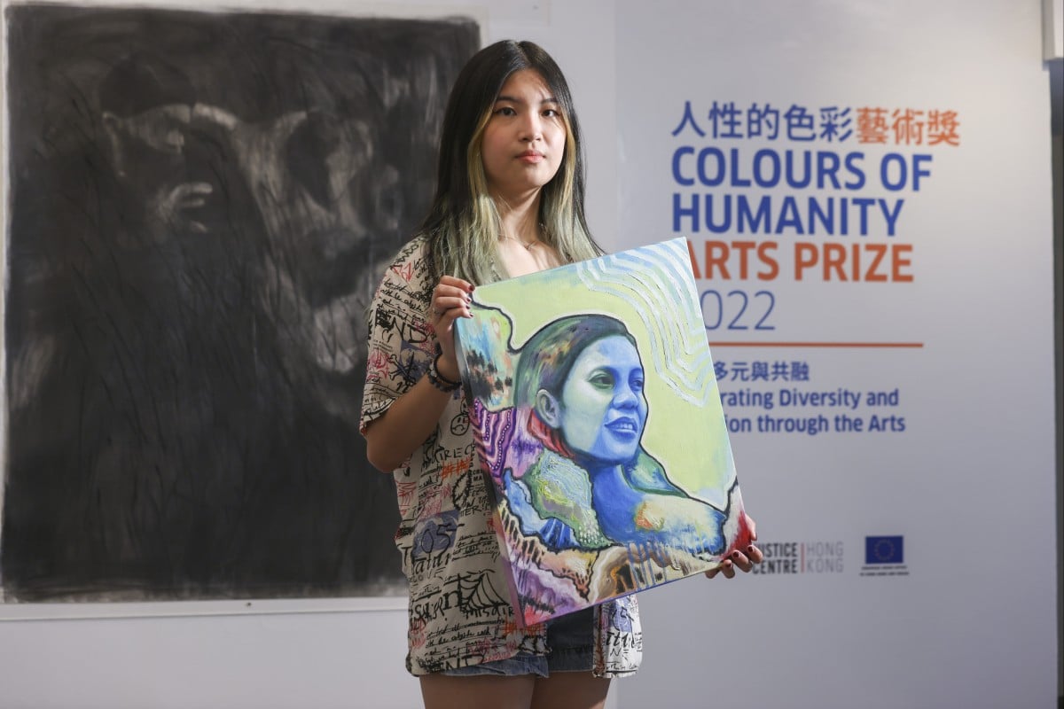 Cheryl Lai holds her painting of Contrinx, who made viral videos reprimanding Hong Kong employers for exploiting domestic workers like herself. Photo: Dickson Lee