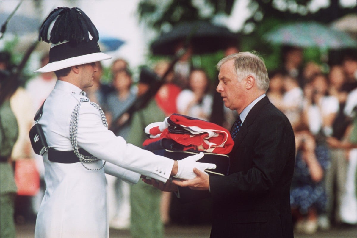 Chris Patten (right) receives the Union Jack flag after it was lowered for the last time at the governor’s official residence during a farewell ceremony in Hong Kong, on June 30, 1997. Photo: AFP
