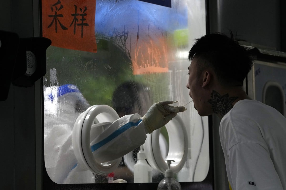 A worker collects a swab sample for Covid-19 testing at a collection point in Beijing. Many people who previously had Covid, even if they recovered some time ago, say they are discriminated against in the job market. Photo: AP