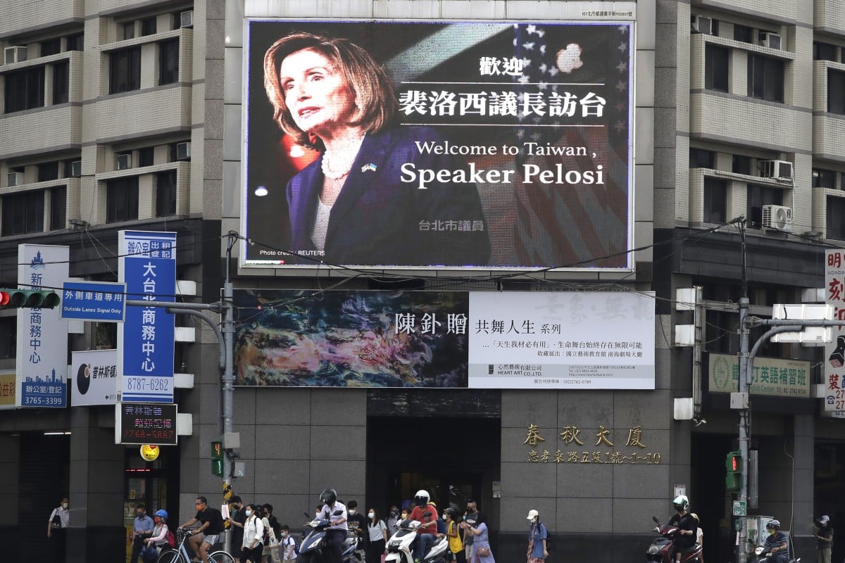 People walk past a billboard welcoming US House Speaker Nancy Pelosi to Taiwan. Photo: AP
