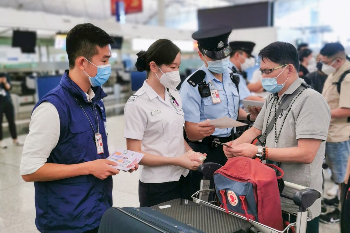 At the Hong Kong airport, police and immigration officers distribute leaflets reminding travellers to beware of employment fraud. Photo: Handout