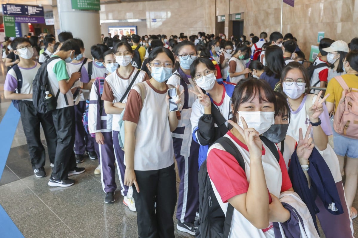 Secondary students pose for a picture at the 32nd HKTDC Hong Kong Book Fair 2022 held in July. Hong Kong still has strict mask measures in place. Photo: Nora Tam