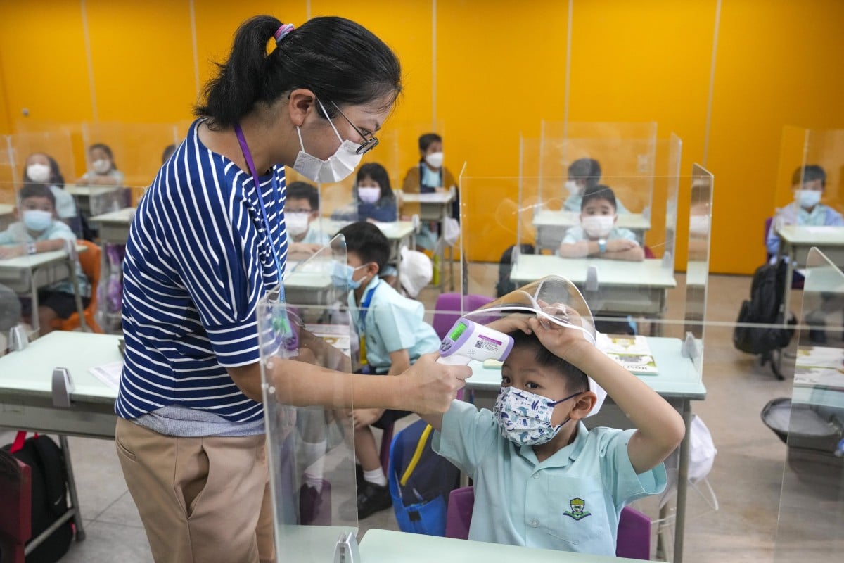 Students head back to school for the new school term at Fukien Secondary School Affiliated School in Yau Tong. Daily temperature checks are just one Covid-19 prevention procedure they need to follow. Photo: Sam Tsang