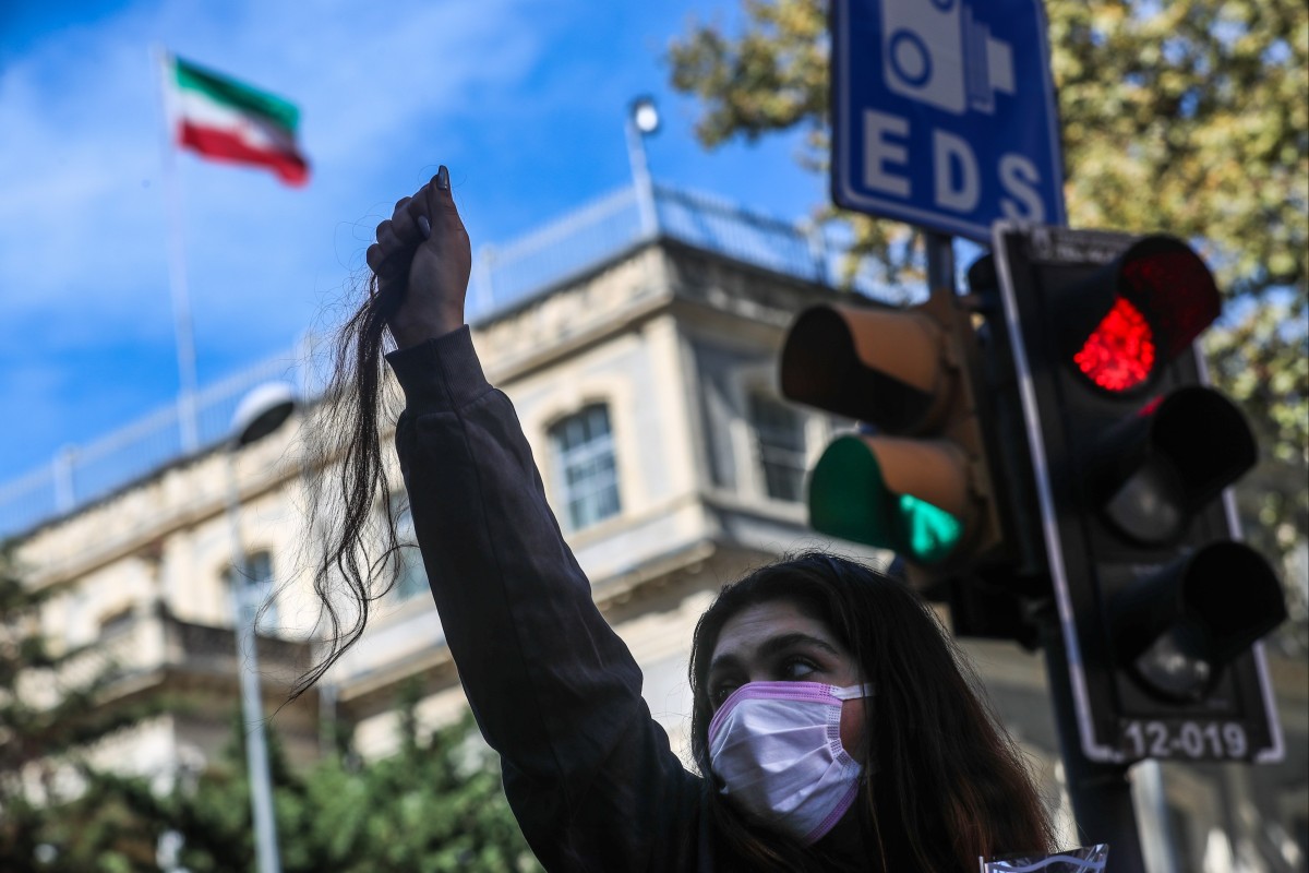 An Iranian woman in Turkey holds a piece of her hair she has cut off during a protest outside the Iranian Consulate following the death of Mahsa Amini. Photo: EPA-EFE