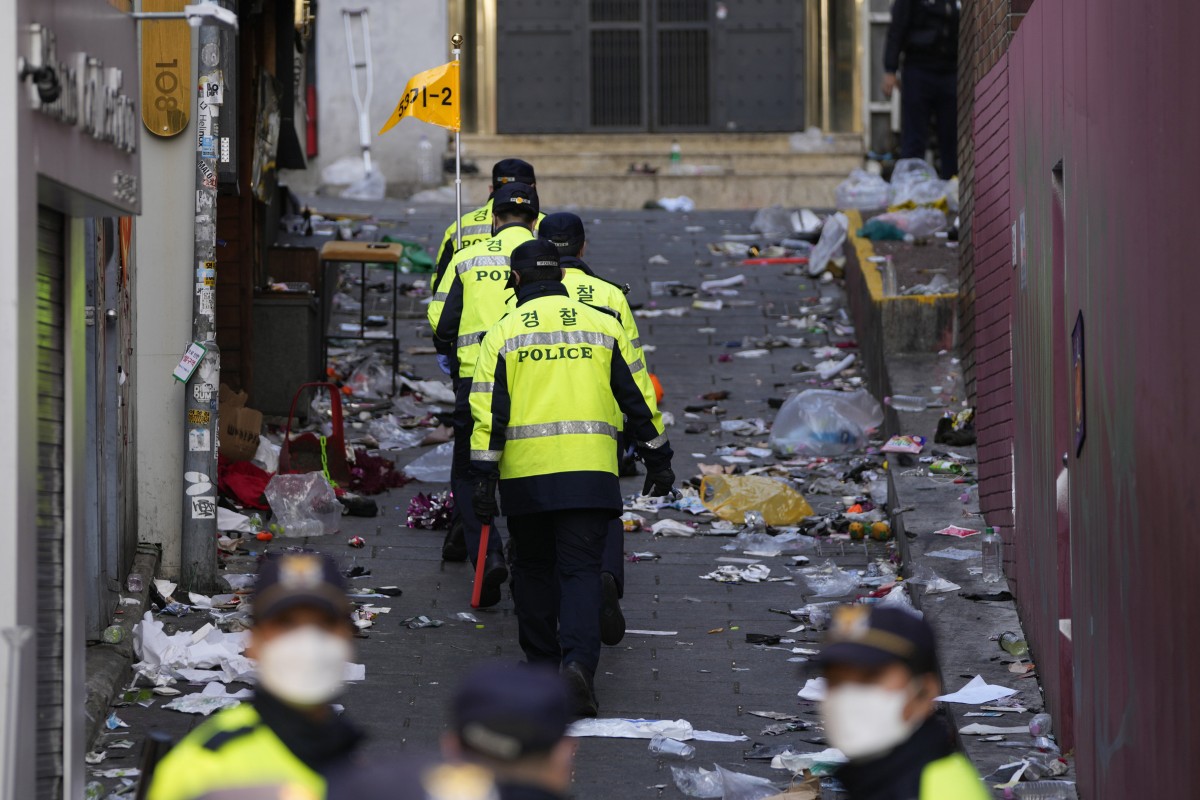 Police officers work at the scene of a fatal crowd surge in Seoul, South Korea. Photo: AP