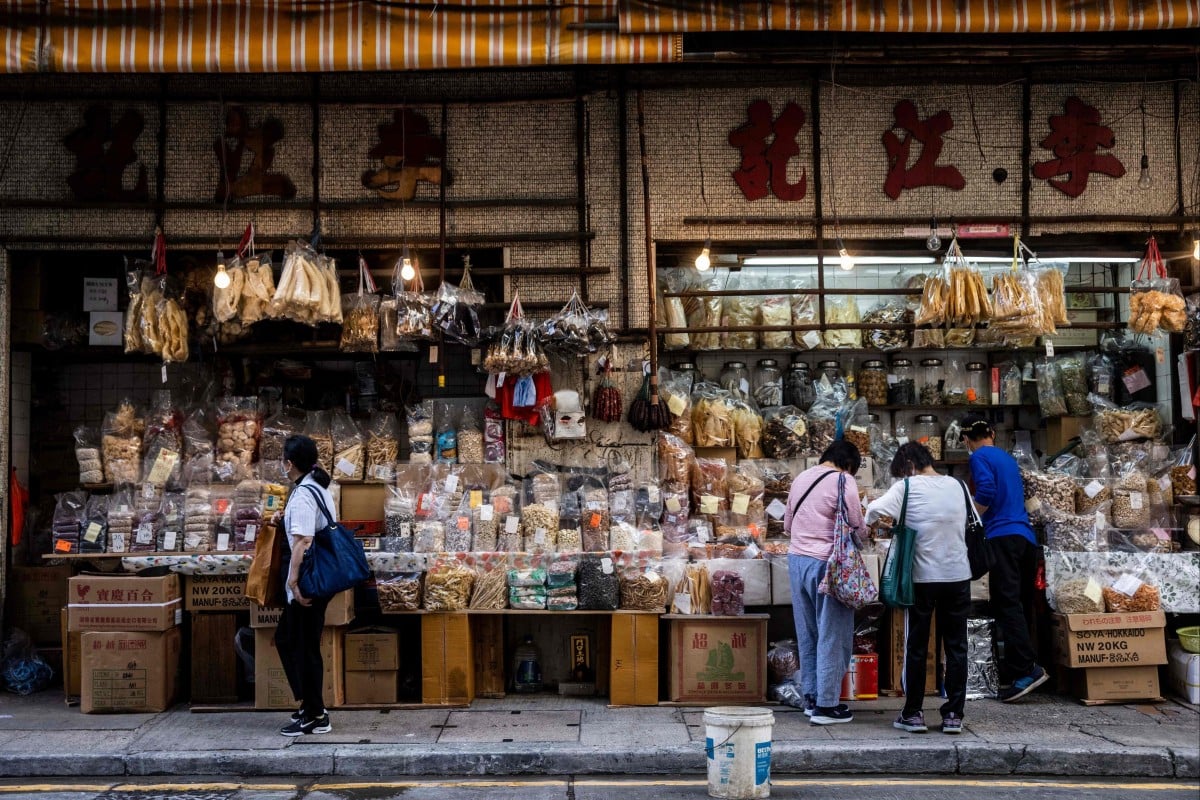 People browse a shop that sells shark fin, dried seafood and other products in Hong Kong. The city’s controversial shark fin trade may face its biggest shakeup in years if conservationists get their way in securing tighter regulations at an international wildlife conference in Panama. Photo: AFP