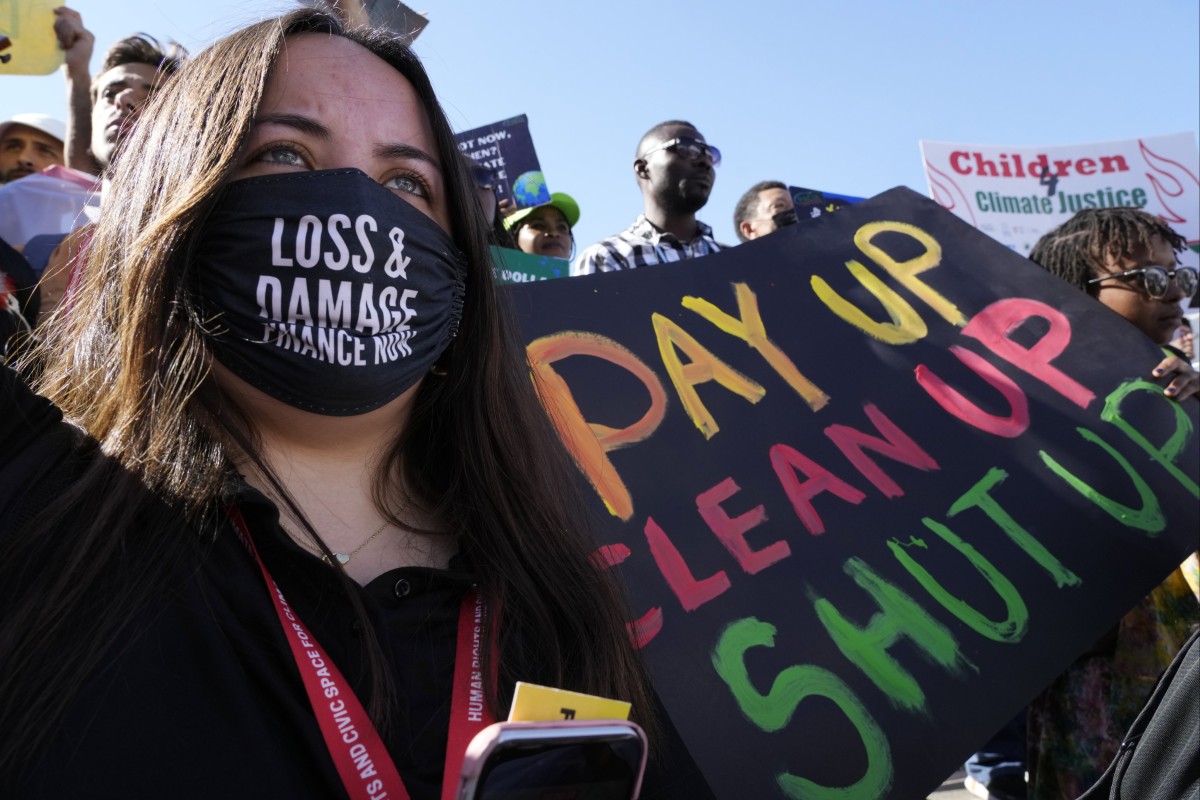 A demonstrator holds a sign during a protest at the COP27 UN Climate Summit on November 12, 2022, in Sharm el-Sheikh, Egypt. Photo: AP