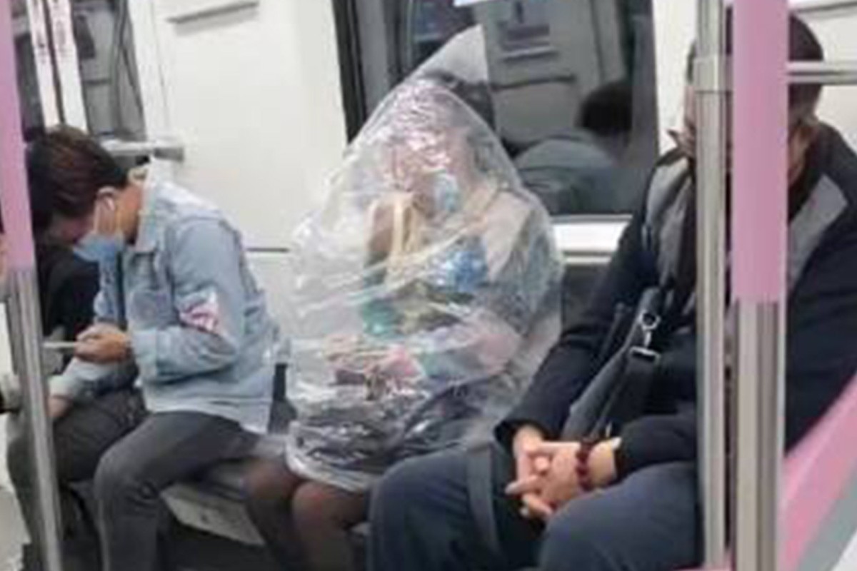 A woman in Wuhan used a huge plastic
bag to cover herself from head to waist to sidestep the no-eating rule on trains. Photo: SCMP