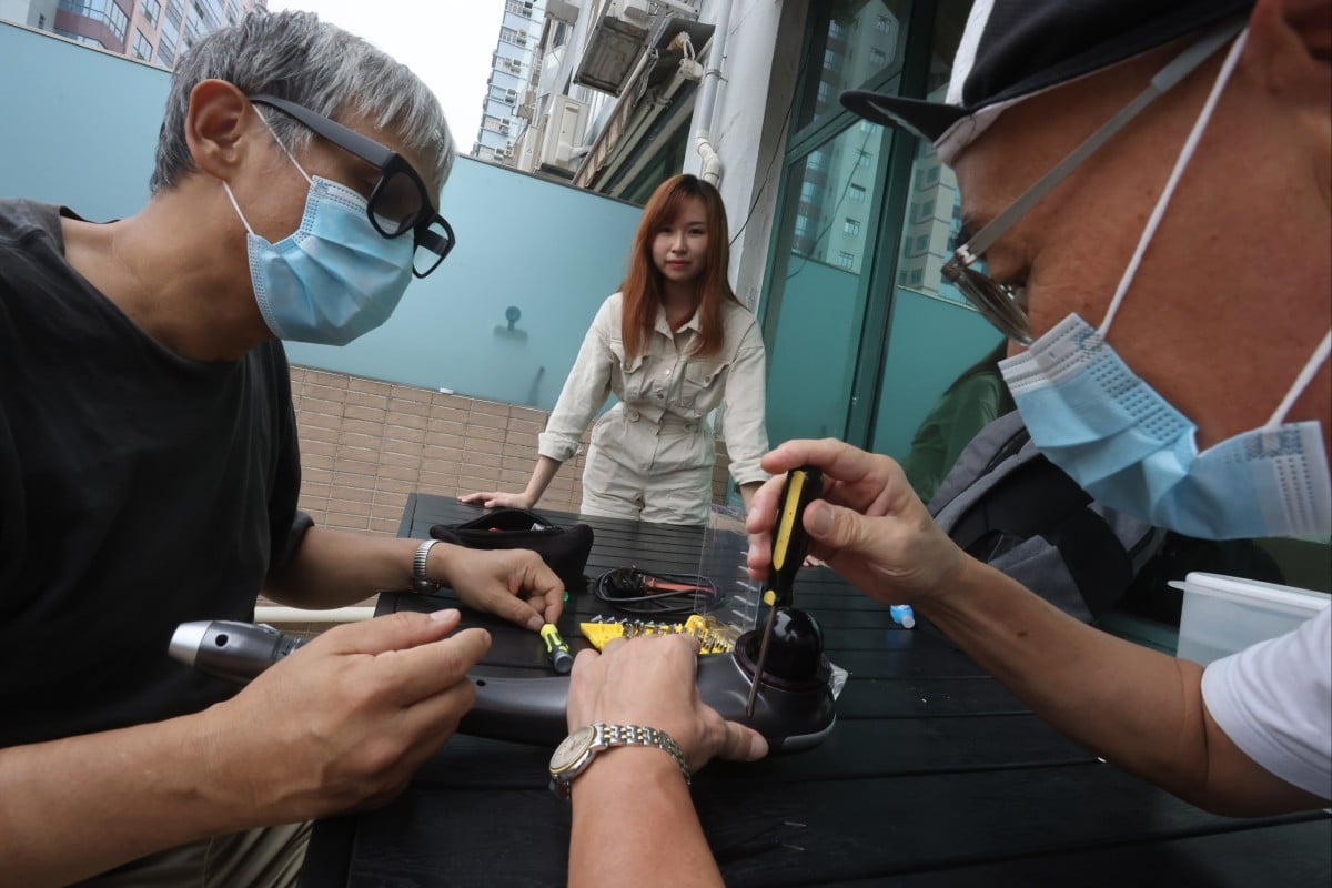 Volunteers at Repair Cafe work to help Hongkongers repair their electronics. The group was co-founded by Kayley Leung (centre). Photo: Jonathan Wong