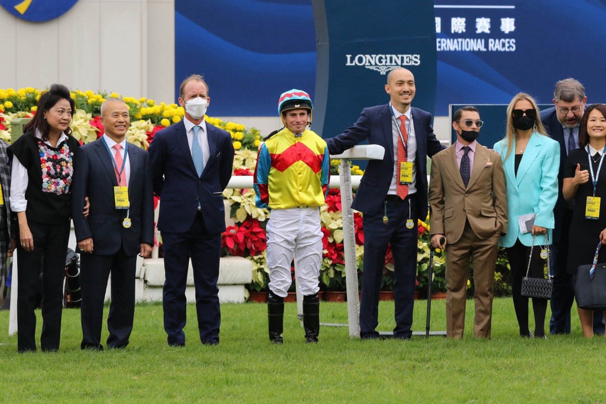 Jockey Alexis Badel (brown suit) with connections after Wellington’s Hong Kong Sprint win. Photo: Kenneth Chan