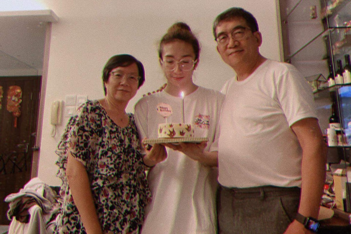 Mo Li poses with his parents. According to his father, the dancer has regained some sensation in his limbs. Photo: Handout