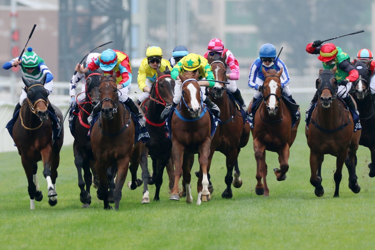 Wellington (pale blue cap) wins the messy Group One Hong Kong Sprint (1,200m) at Sha Tin on December 11. Photo: Kenneth Chan