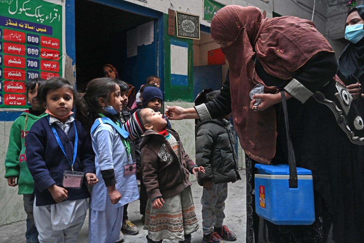 A health worker administers polio vaccine drops to a child during a vaccination campaign in Pakistan. Photo: AFP