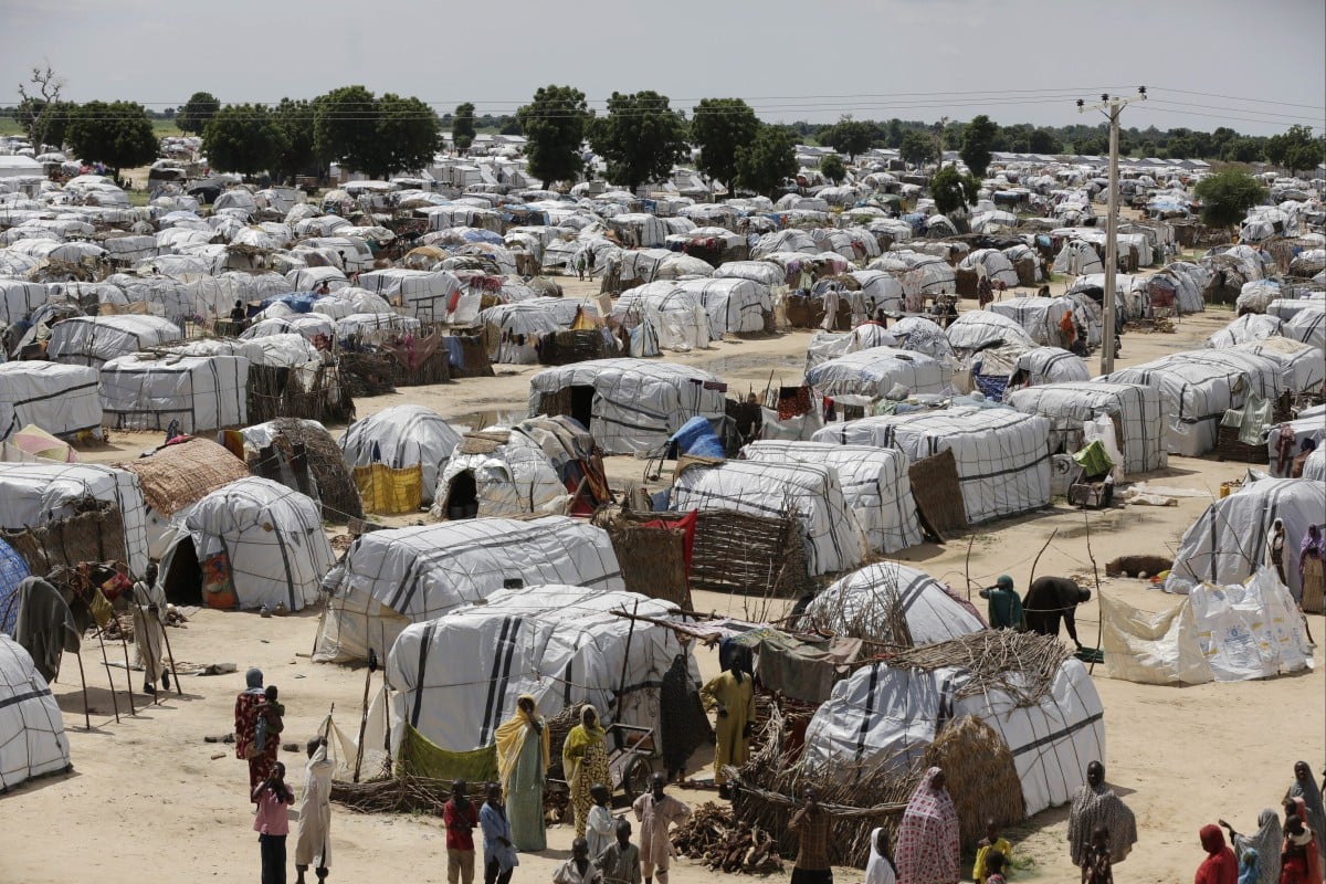 A top view of one of the biggest camps for people displaced by Islamic extremists in Maiduguri, Nigeria on August 28, 2016. Droughts, flooding and a shrinking Lake Chad caused in part by climate change is fueling conflict and migration in the region. Photo: AP/Sunday Alamba