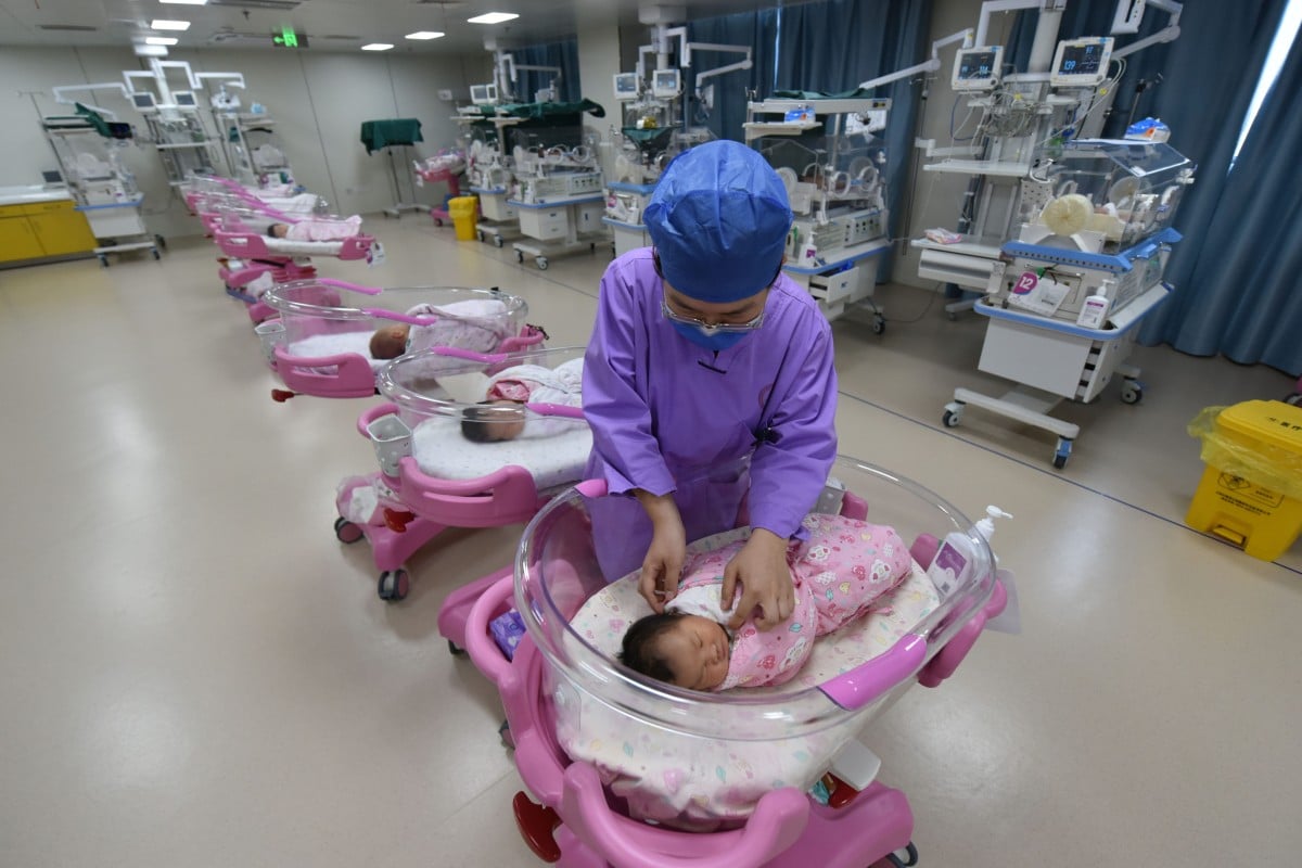 A nurse takes care of newborn babies in a maternity hospital in Fuyang, Anhui province. Photo: Getty Images