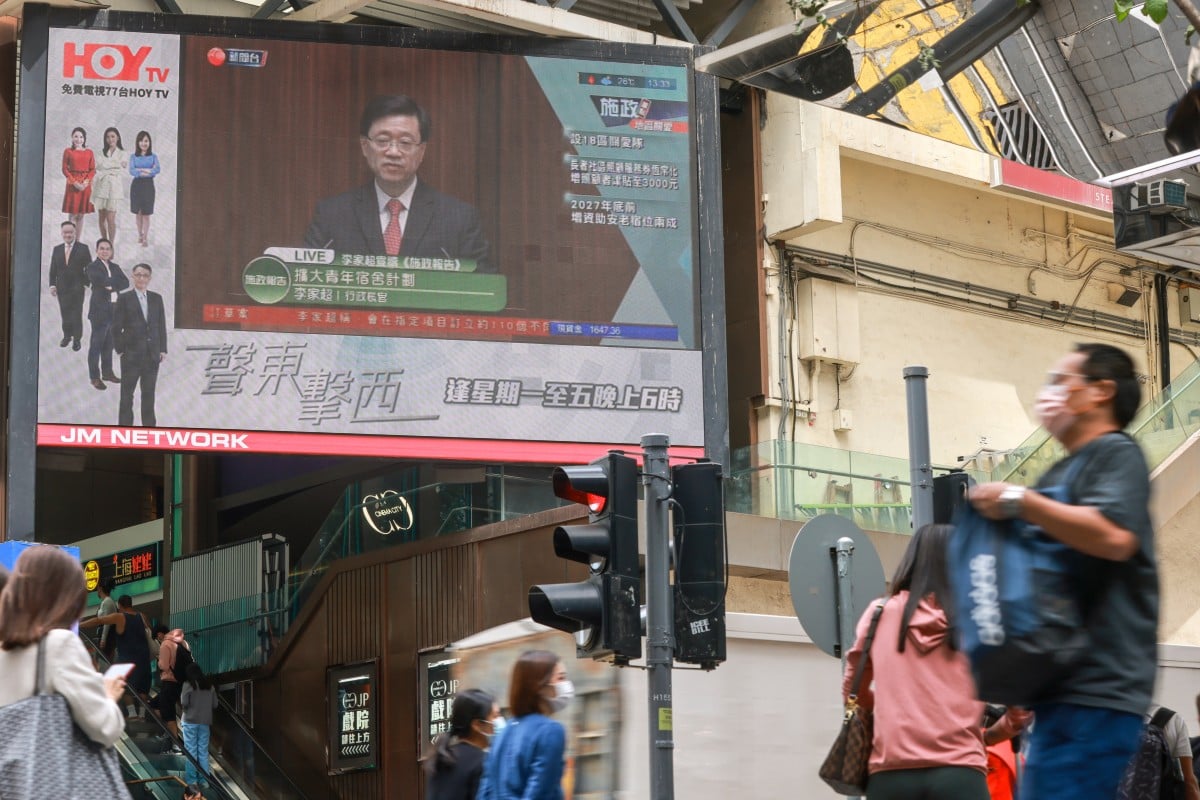 A giant screen shows a HOY TV report on Hong Kong Chief Executive John Lee Ka-chiu. Photo May Tse