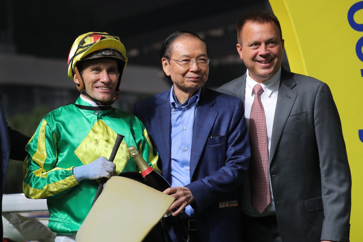 Luke Currie (left) and Caspar Fownes (right) celebrate Lucky Banner’s win at Sha Tin on Wednesday night with connections. Photo: Kenneth Chan