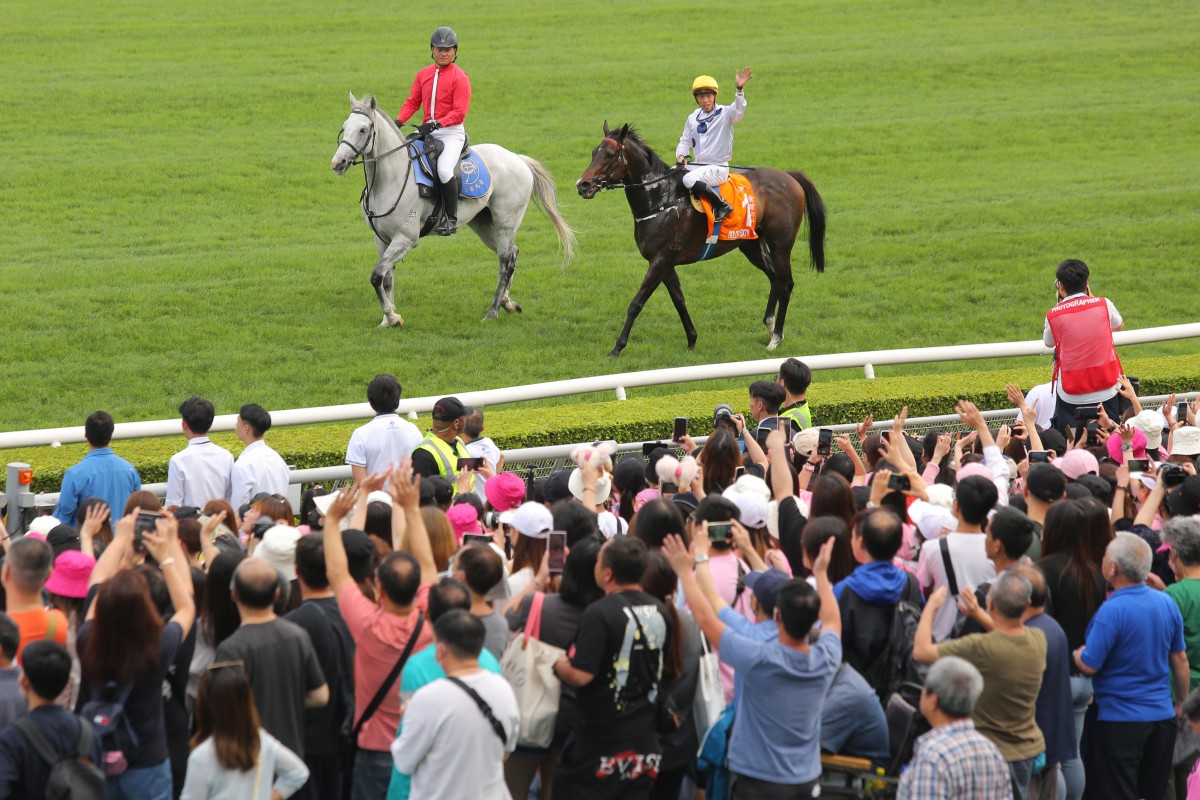 Jockey Vincent Ho waves to the crowd after Golden Sixty’s Champions Mile victory at Sha Tin on Sunday. Photo: Kenneth Chan