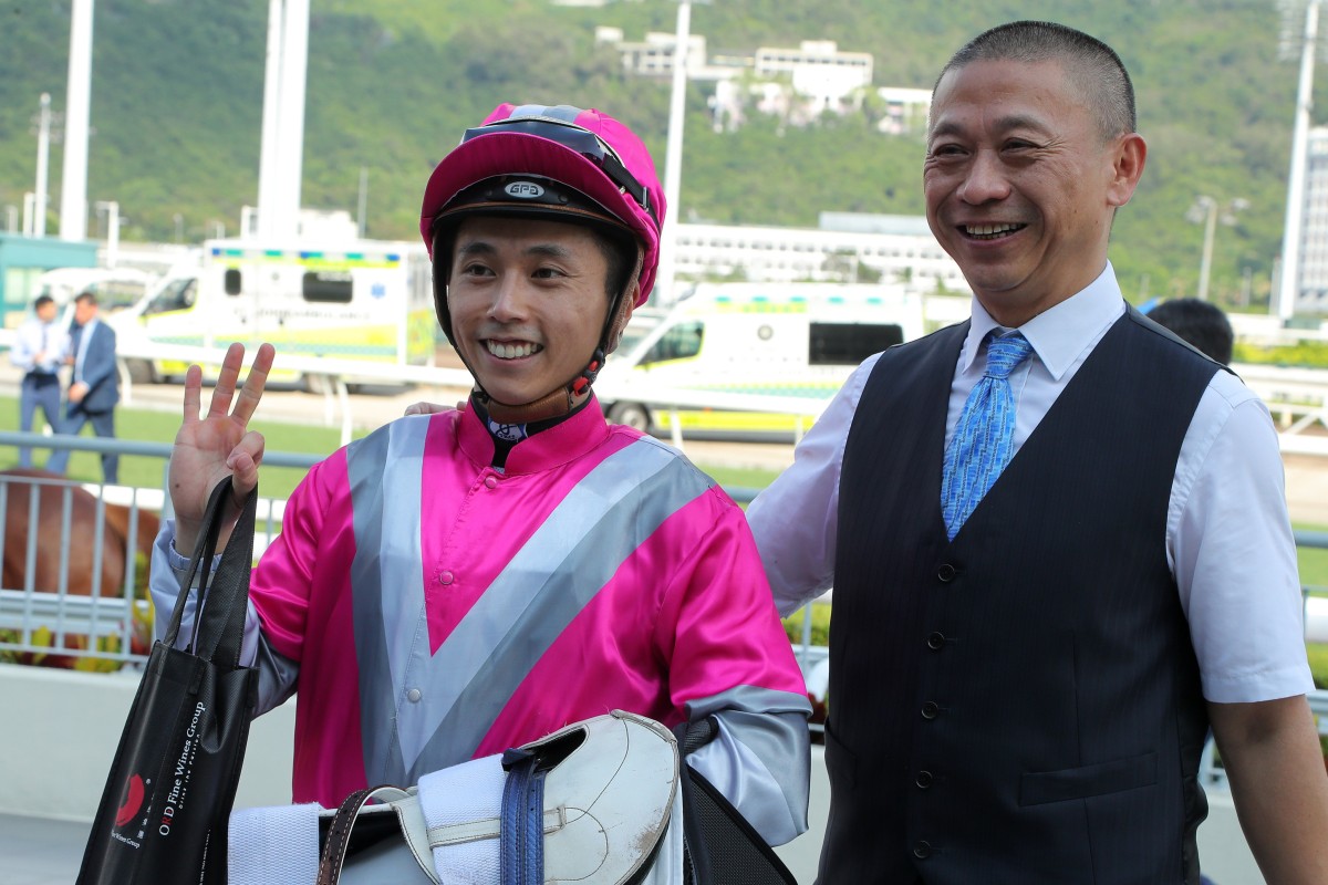 Matthew Poon celebrates completing his Sha Tin treble on Sunday with Ka Ying Spirit’s trainer, Danny Shum. Photo: Kenneth Chan