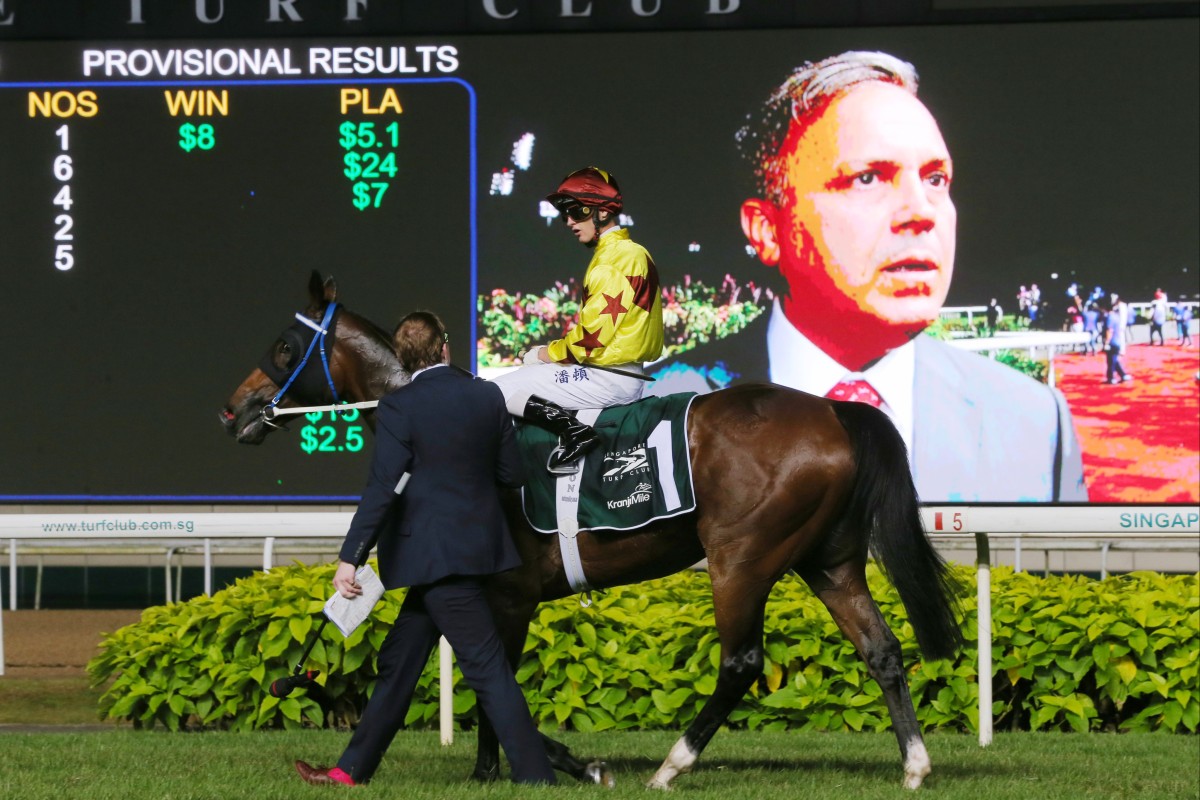 Zac Purton and Southern Legend return after winning the 2019 Kranji Mile, while trainer Caspar Fownes is interviewed on the big screen. Photos: Kenneth Chan
