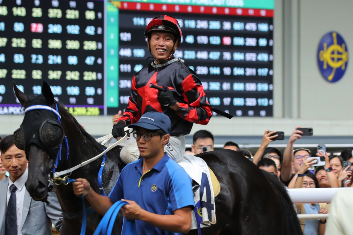 Vincent Ho is all smiles after winning aboard Dancing Code at Happy Valley on Wednesday night. Photo: Kenneth Chan