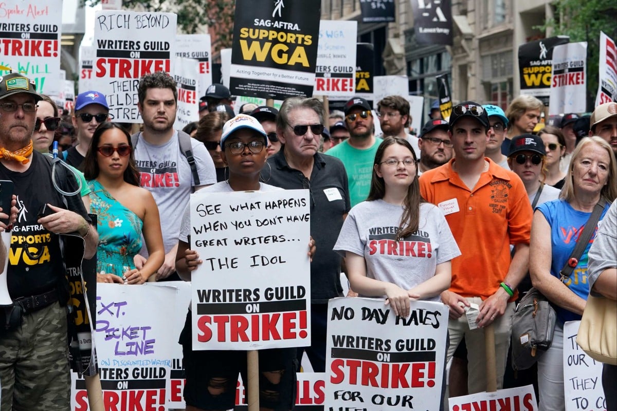 Members of the Writers Guild of America and the Screen Actors Guild pose for a photo while walking a picket line outside of Warner Bros in New York on July 13, 2023. Actors will go on strike on Friday, joining writers in the first industry-wide shutdown in 63 years after last-ditch talks failed, with nearly all film and television production likely to grind to a halt. Photo: AFP