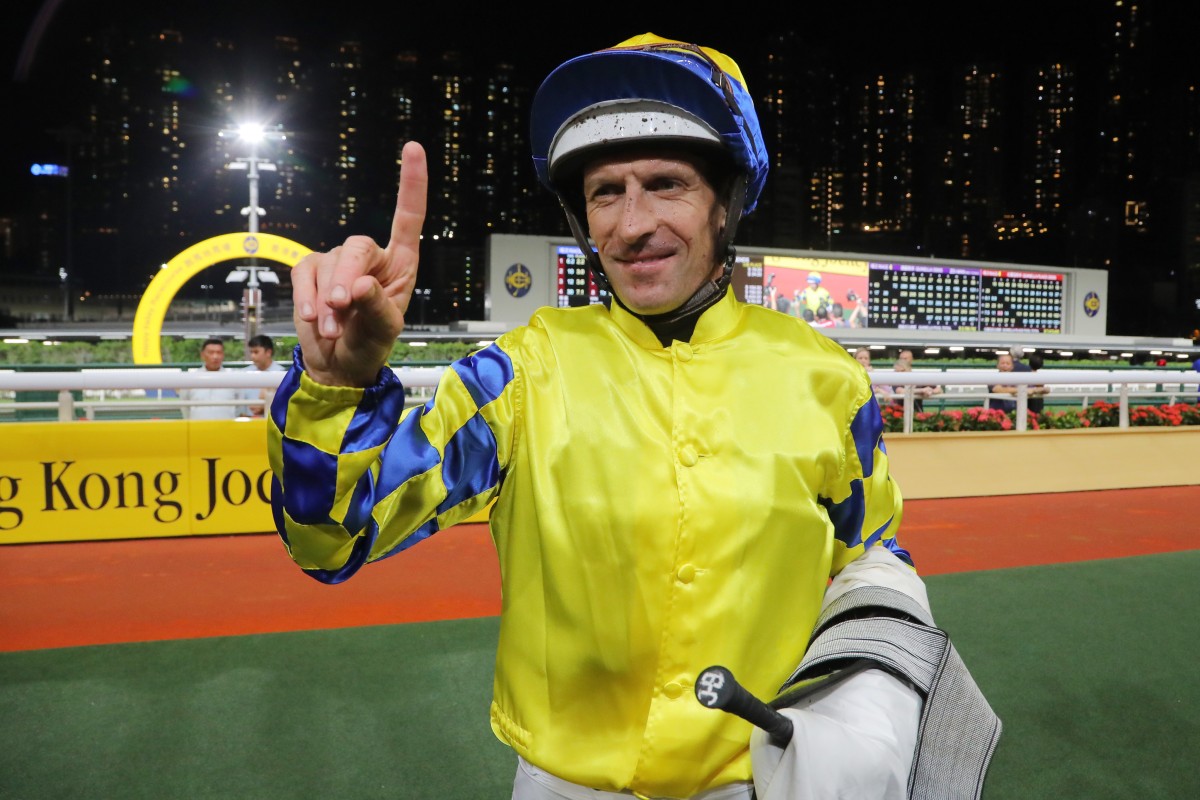 Hugh Bowman celebrates his 100th Hong Kong win after saluting aboard June Planet at Happy Valley last night. Photo: Kenneth Chan