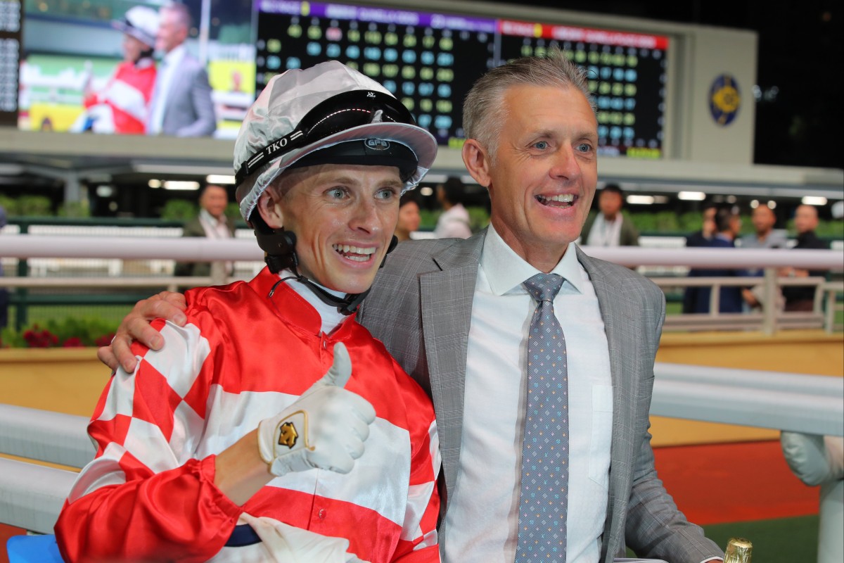 A beaming Mark Newnham celebrates his first Hong Kong win with jockey Lyle Hewitson. Photo: Kenneth Chan