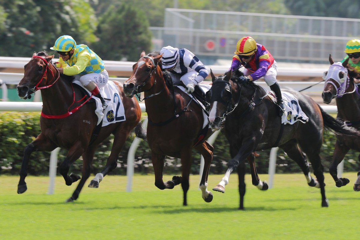 Andrea Atzeni lifts Champion Method (left) to victory at Sha Tin on  Sunday. Photo: Kenneth Chan