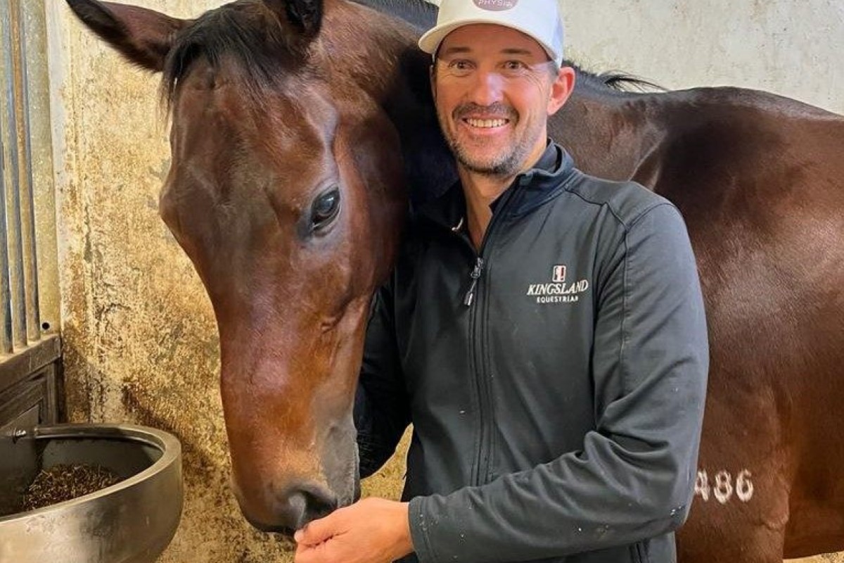 Equine physio Tom Simpson with Hong Kong superstar Romantic Warrior. Photo: Handout
