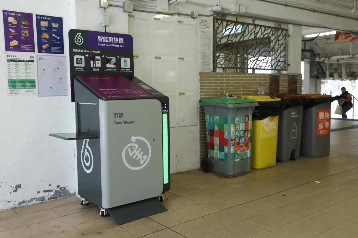 A smart food waste bin for Hong Kong's mobile recycling initiative in 2025 is situated near other colorful recycling containers indoors.