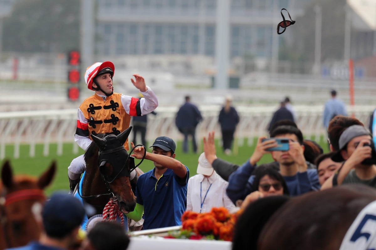 Jockey Brenton Avdulla sends his goggles into the crowd after saluting aboard Atullibigeal. Photos: Kenneth Chan