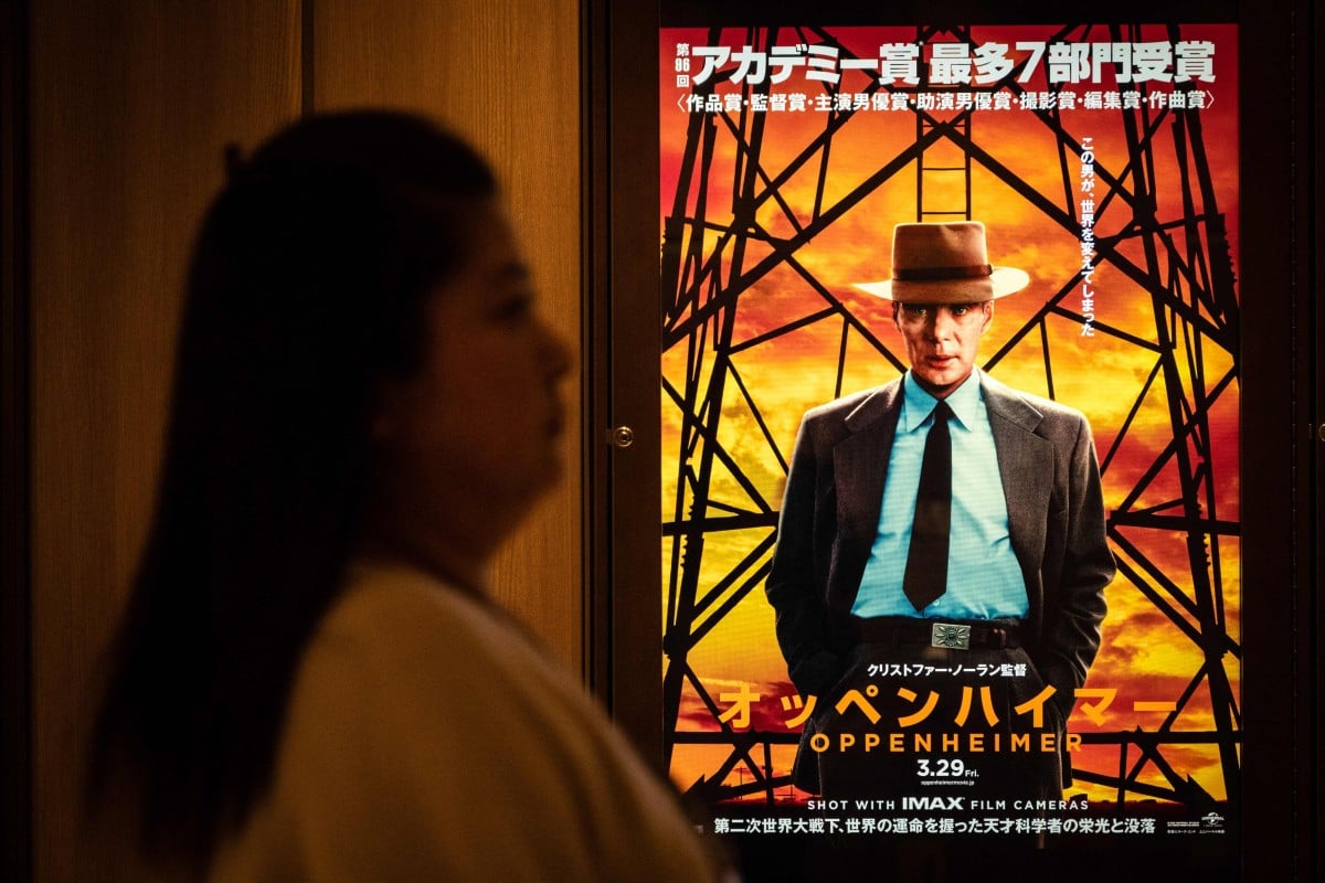 A woman walks past an advertisement for “Oppenheimer” in Tokyo on March 29, 2024. Photo: AFP