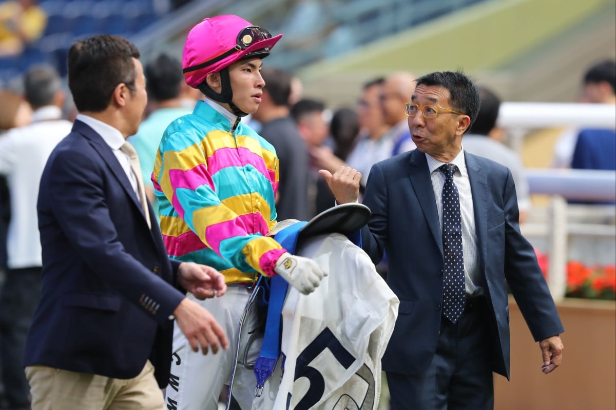 Trainer Me Tsui (right) discusses Super Axiom’s midweek victory with jockey Ellis Wong. Photos: Kenneth Chan