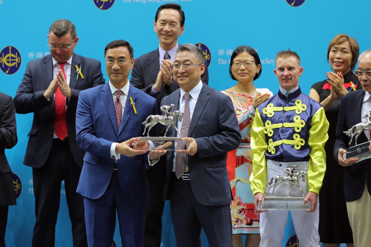 Jockey Club chairman Michael Lee presents Francis Lui with his champion trainer trophy. Photos: Kenneth Chan