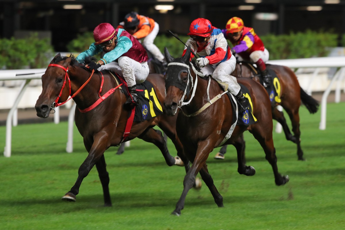 Karis Teetan lifts Take Action (inside) to a narrow win over Ninja Derby at Happy Valley. Photos: Kenneth Chan