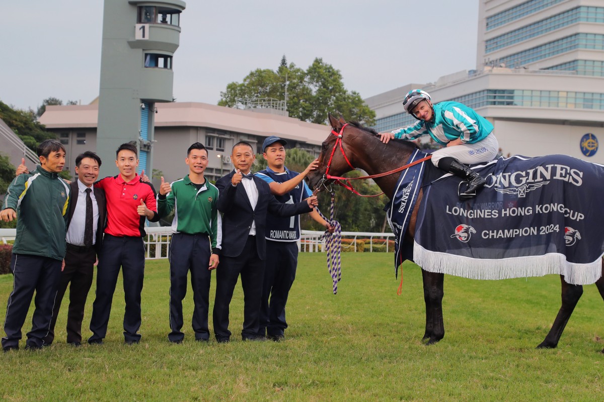 Jockey James McDonald and trainer Danny Shum enjoy Romantic Warrior’s Hong Kong Cup victory with stable staff. Photo: Kenneth Chan