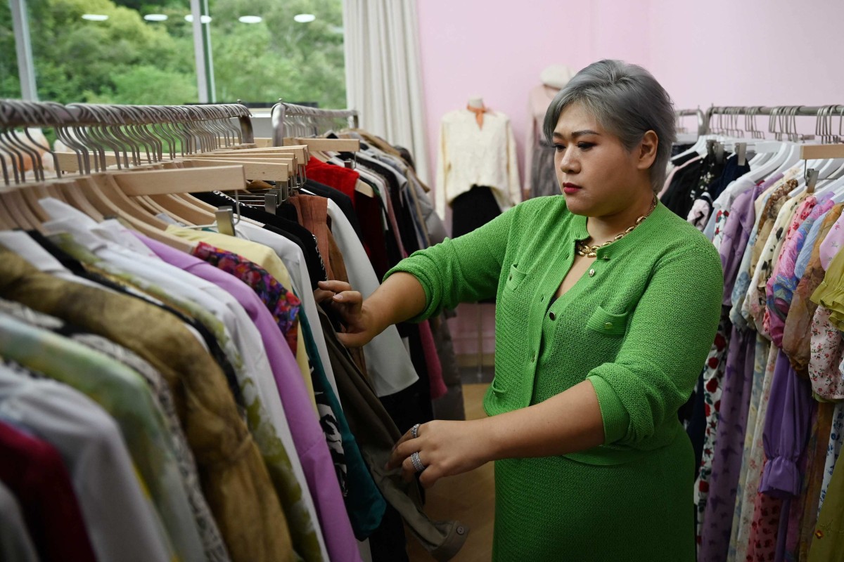 Brand owner and influencer Amanda Yao inspects clothes in her office in Guangzhou. Photo: AFP