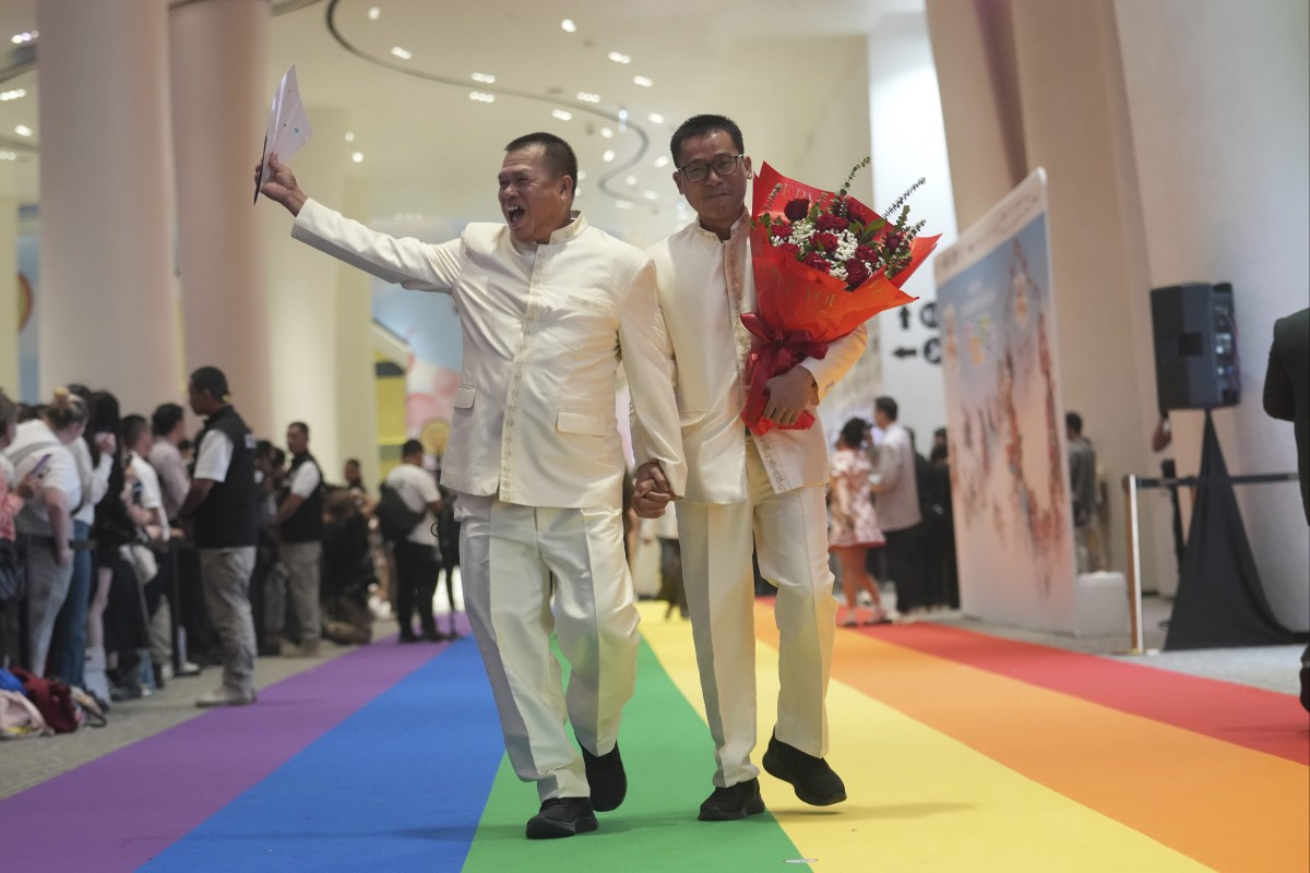 A just-married couple walks on a rainbow carpet in Bangkok, Thailand, on January 23, 2025, the first day a marriage equality law took effect. Photo: AP