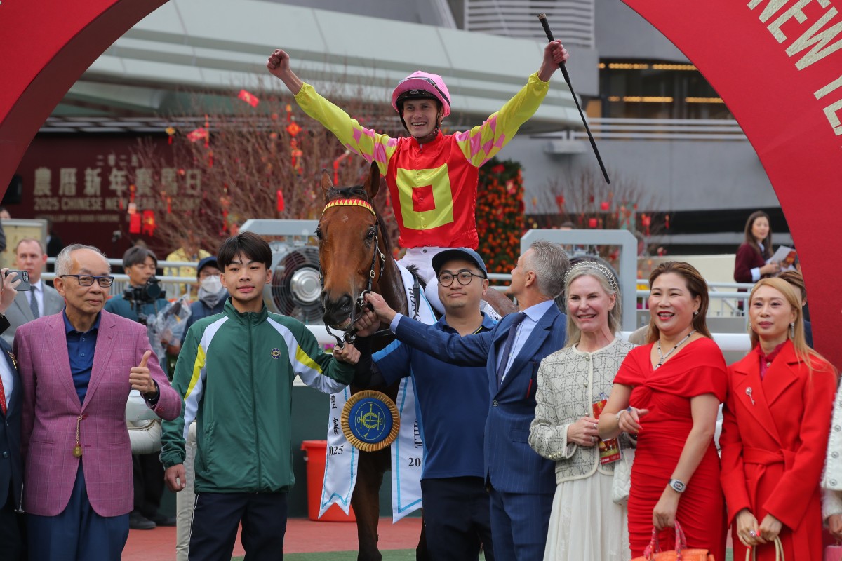 Jockey Luke Ferraris celebrates his Classic Mile win on My Wish with connections. Photos: Kenneth Chan