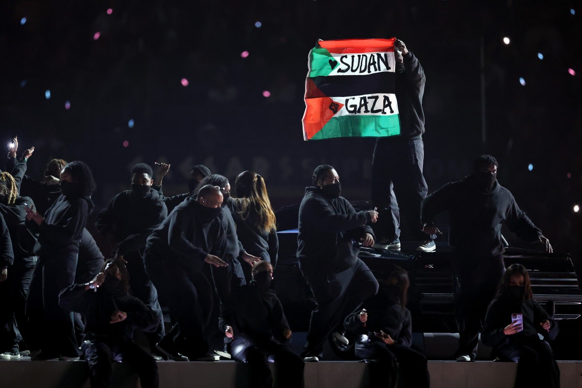 A protester holds a flag onstage during the Apple Music Super Bowl LIX Halftime Show at Caesars Superdome on Sunday, February 9, 2025, in New Orleans, Louisiana, United States. Photo: Getty Images/TNS