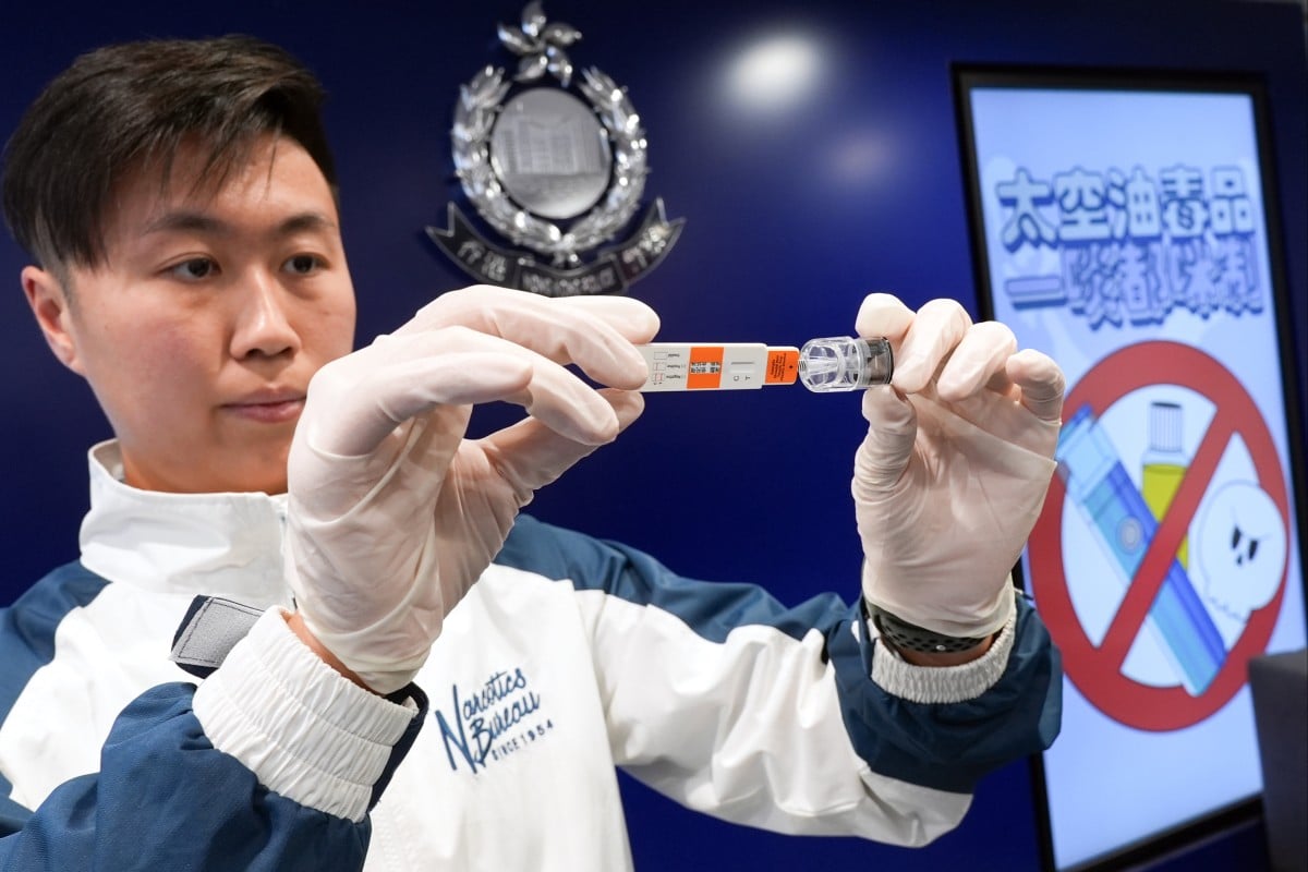 An officer from the Hong Kong Police’s Narcotics Bureau demonstrates the “space oil” rapid test at Police Headquarters in Wan Chai. Photo: Eugene Lee