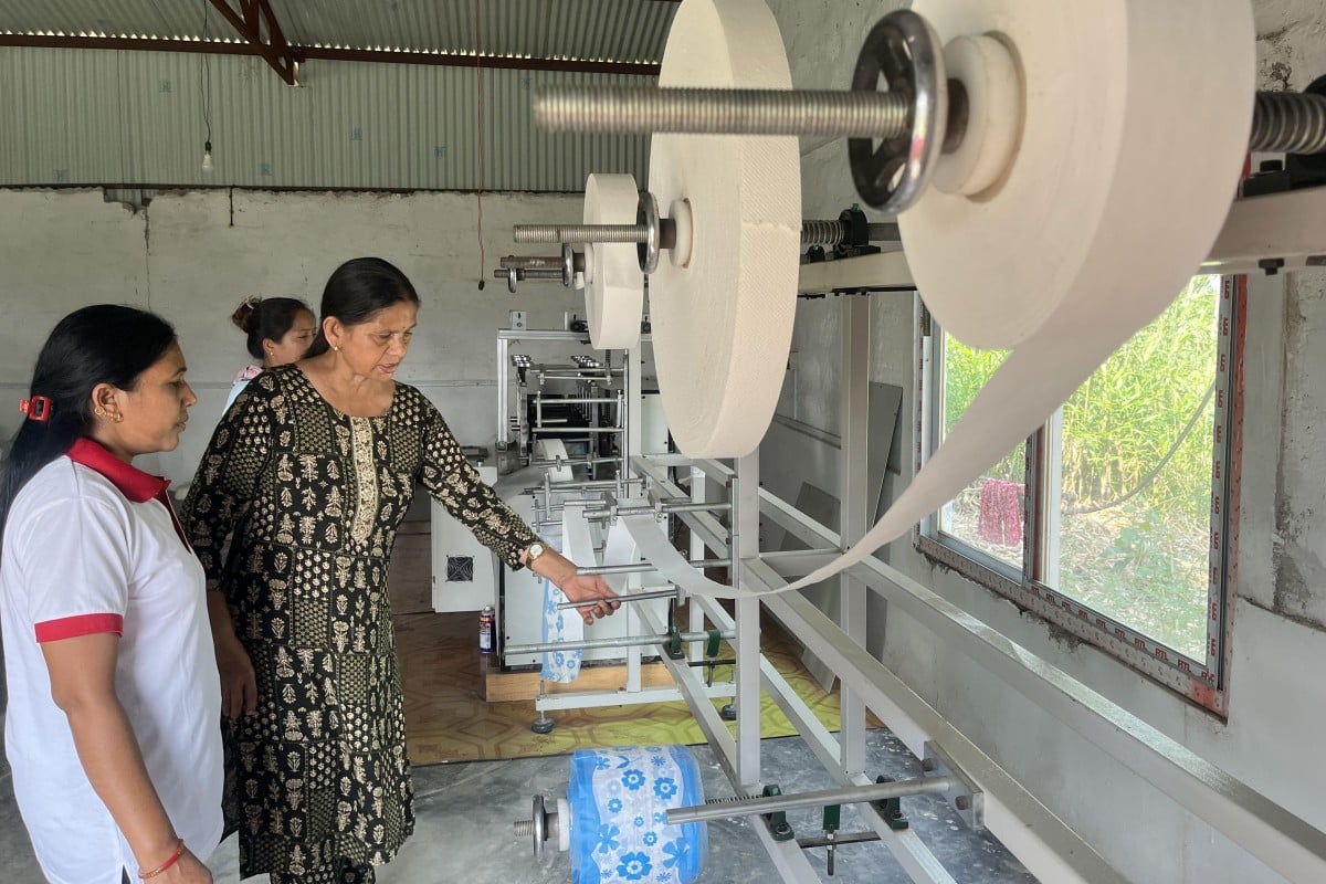 Sabitri Bhandari, coordinator of the Miteri Jaibik Pad Udhyog factory in Chitwan, inspects a pad-making machine. Photo: Bibek Bhandari