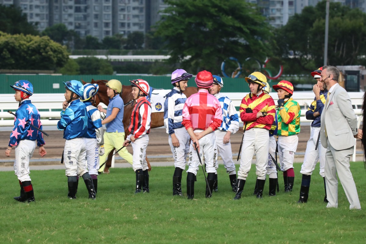 Jockeys mill around during delays to the start of race 10 at Sha Tin on Sunday. Photos: Kenneth Chan